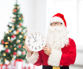 Image showing man in costume of santa claus with clock