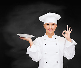 Image showing female chef with empty plate showing ok sign