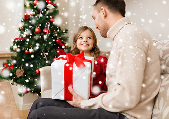 Image showing smiling father and daughter holding gift box