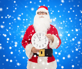 Image showing man in costume of santa claus with clock