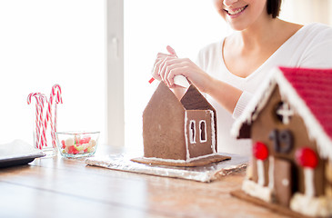 Image showing close up of woman making gingerbread houses