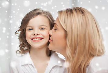 Image showing happy mother and daughter cuddling