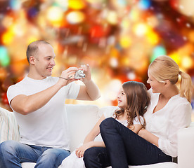 Image showing happy family with camera at home