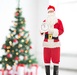 Image showing man in costume of santa claus with clock