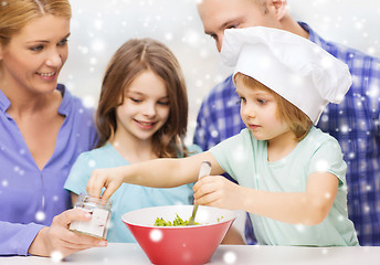 Image showing happy family with two kids making salad at home