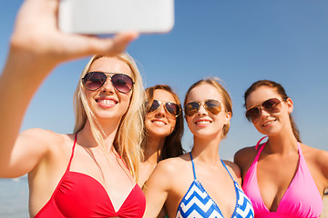 Image showing group of smiling women making selfie on beach