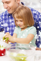 Image showing happy father with girl making dinner at home