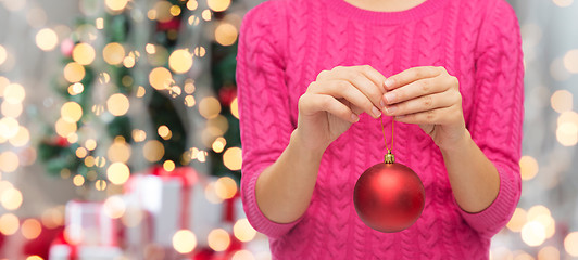 Image showing close up of woman in sweater with christmas ball