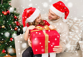 Image showing smiling father and daughter holding gift box