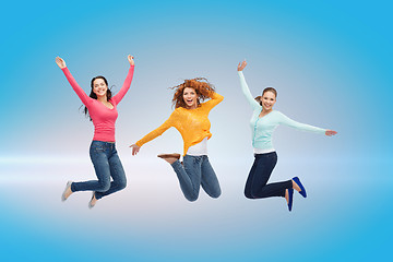 Image showing smiling young women jumping in air