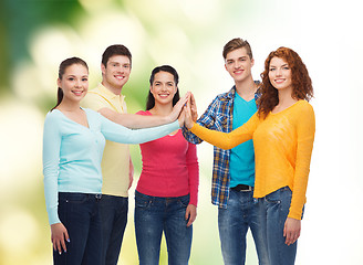 Image showing group of smiling teenagers over green background