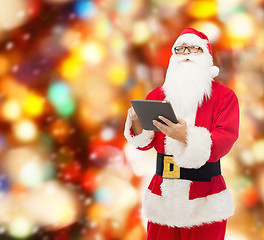 Image showing man in costume of santa claus with tablet pc