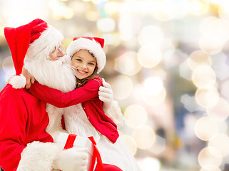 Image showing smiling little girl with santa claus