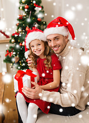 Image showing smiling father and daughter holding gift box