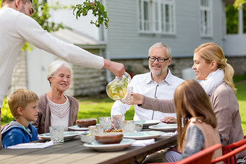 Image showing happy family having holiday dinner outdoors