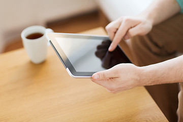 Image showing close up of man with laptop and cup at home