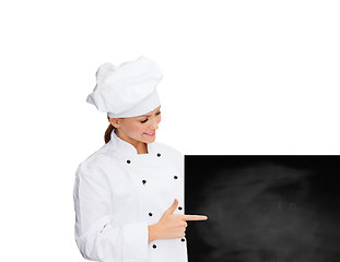 Image showing smiling female chef with white blank board