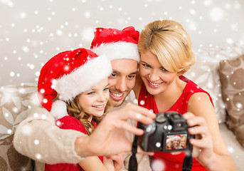 Image showing happy family with digital camera taking photo