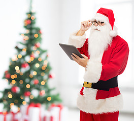 Image showing man in costume of santa claus with tablet pc