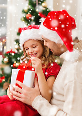 Image showing smiling father and daughter holding gift box