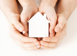 Image showing man and woman hands with white paper house