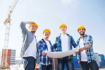 Image showing group of builders with tablet pc and blueprint