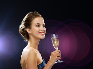 Image showing smiling woman holding glass of sparkling wine