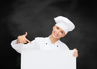 Image showing smiling female chef with white blank board