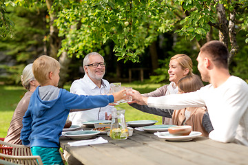 Image showing happy family having holiday dinner outdoors