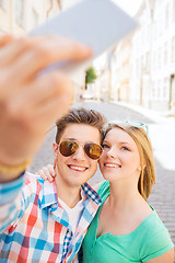 Image showing smiling couple with smartphone in city