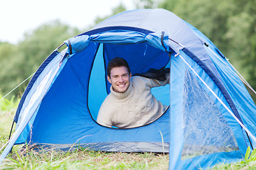 Image showing smiling male tourist in tent