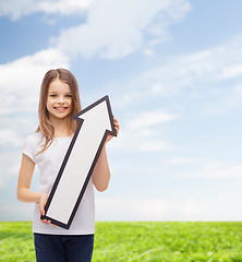 Image showing smiling little girl with blank arrow pointing up