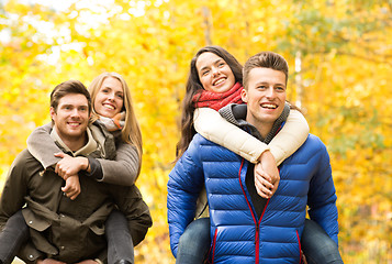 Image showing smiling friends having fun in autumn park