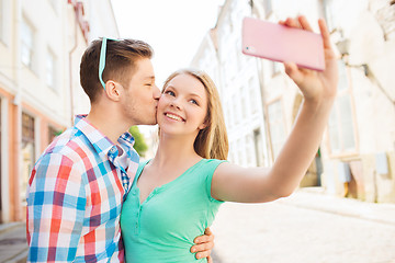 Image showing smiling couple with smartphone in city