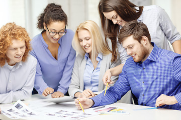 Image showing smiling team with color samples at office