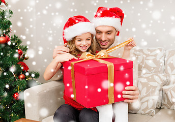 Image showing smiling father and daughter holding gift box