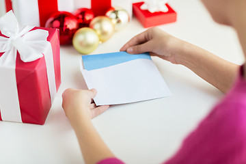 Image showing close up of woman with letter and presents