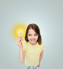 Image showing smiling little girl holding light bulb