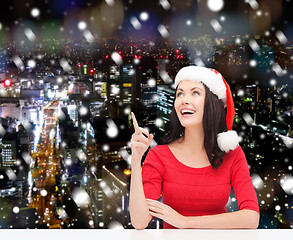 Image showing smiling woman in santa helper hat