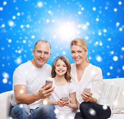 Image showing happy family with smartphones