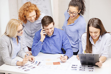 Image showing creative team with papers and clipboard at office