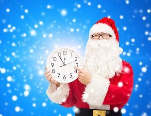 Image showing man in costume of santa claus with clock