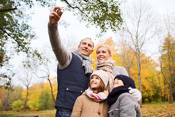 Image showing happy family with camera in autumn  park