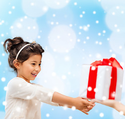 Image showing smiling little girl with gift box