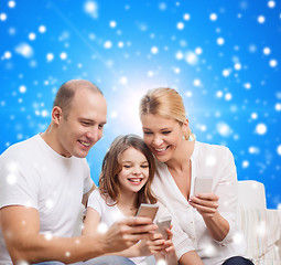 Image showing happy family with smartphones