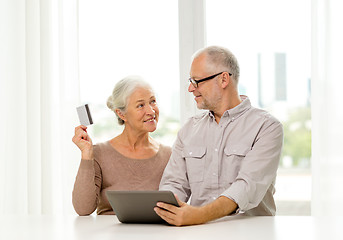 Image showing happy senior couple with tablet pc and credit card