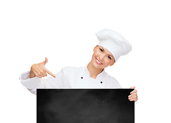 Image showing smiling female chef with white blank board