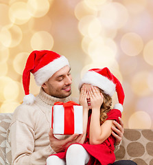 Image showing smiling daughter waiting for present from father