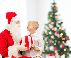 Image showing smiling little boy with santa claus and gifts