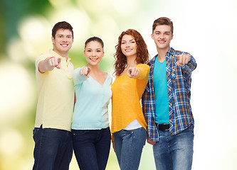 Image showing group of smiling teenagers over green background